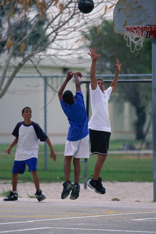 Teenagers playing pick up basketball