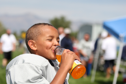 Young football player drinking sports drink