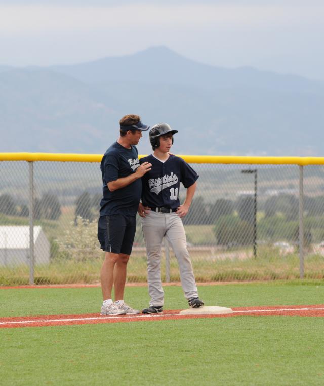 Baseball coach talking to player
