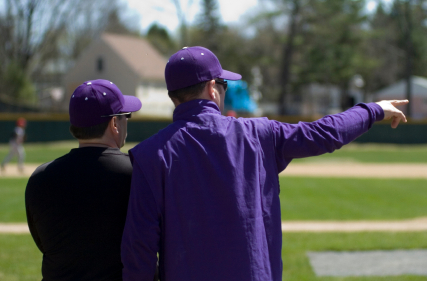 Baseball coaches pointing to outfield