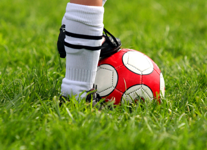 Close up of soccer players' feet and soccer ball