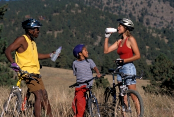 Family stopping on bike ride to drink water