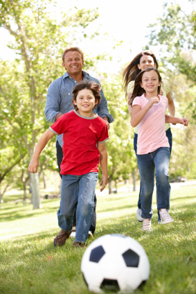Family chasing soccer ball