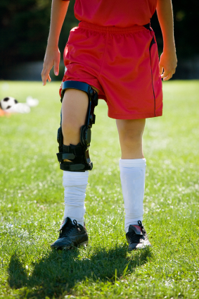 Female soccer player with ACL knee brace