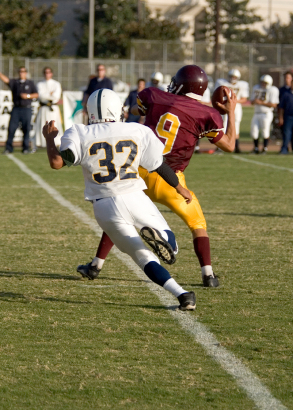 Football quarterback throwing pass
