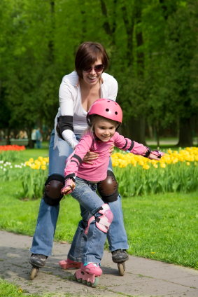 Mother teaching child to roller skate
