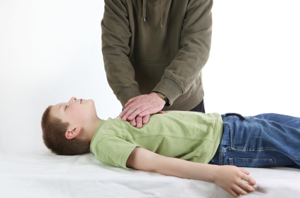 Adult performing CPR on a child