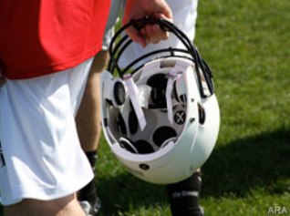 Football player holding helmet