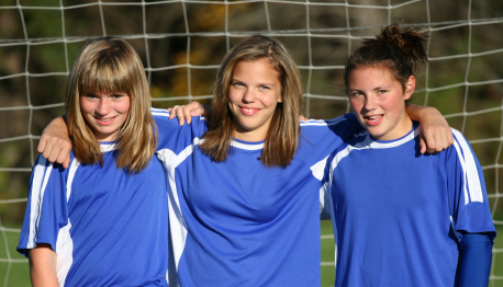 Three teenage girl soccer players 