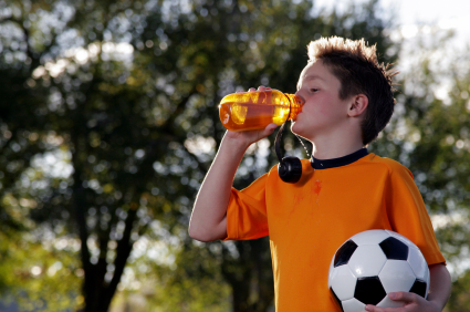 Young soccer player drinking sports drink