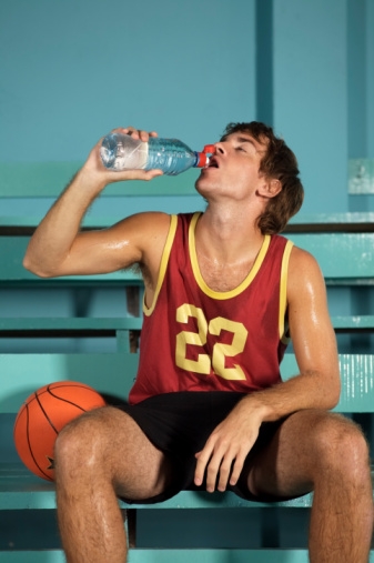Basketball player guzzling water bottle
