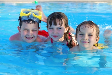 Three kids swimming