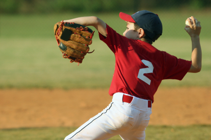 Young baseball pitcher about to deliver pitch