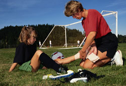 Coach Wrapping Athlete's Ankle