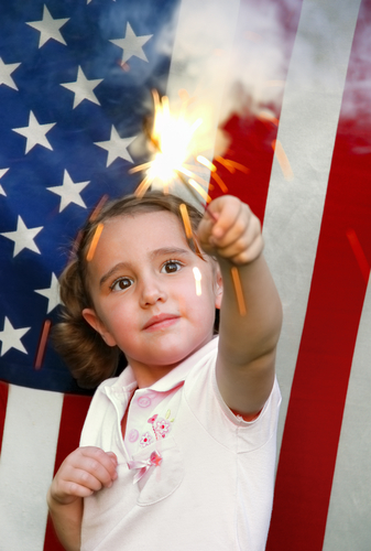 Girl with sparkler in front of American flag