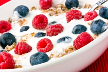 Bowl of cereal with milk, blueberries and raspberries