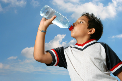Young athlete drinking from a water bottle