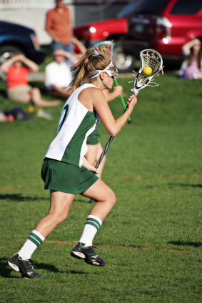 Girl's lacrosse player cradling ball in her stick