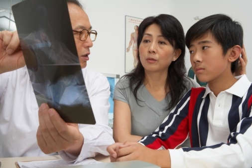Doctor showing mom and son x-ray