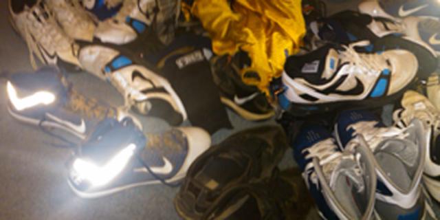 Collection of athletic shoes on the floor of a kid's bedroom