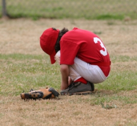 Sad youth baseball player