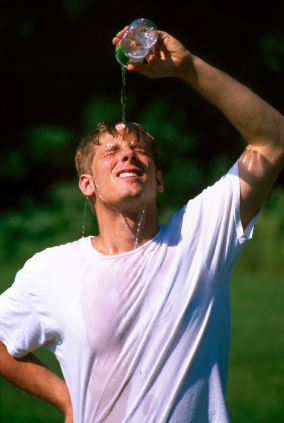 Athlete cooling off by pouring water on head
