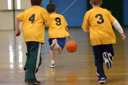 Young basketball players running up court